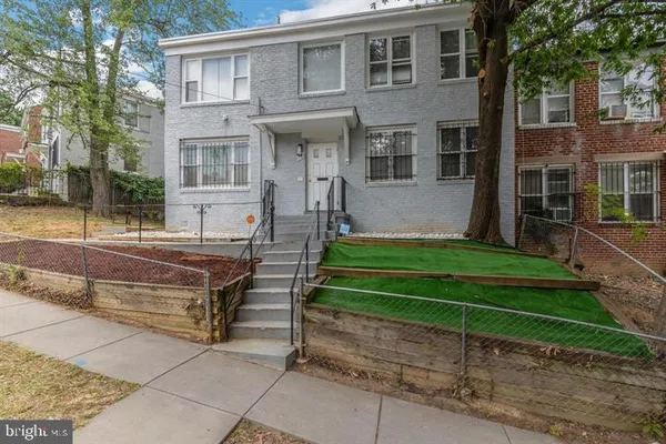 a front view of a house with a yard table and chairs
