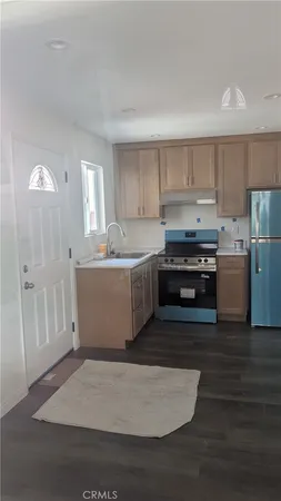 a kitchen with wooden cabinets and a stove top oven