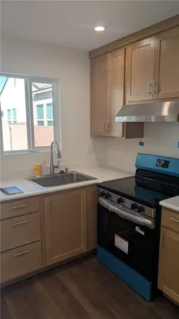 a kitchen with a stove refrigerator and cabinets