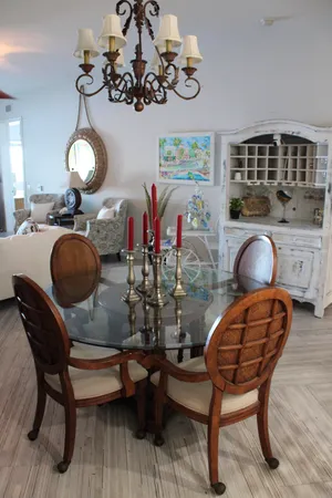 a room with a table chairs and a chandelier