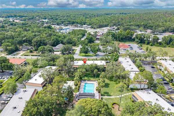 an aerial view of residential houses with outdoor space and street view