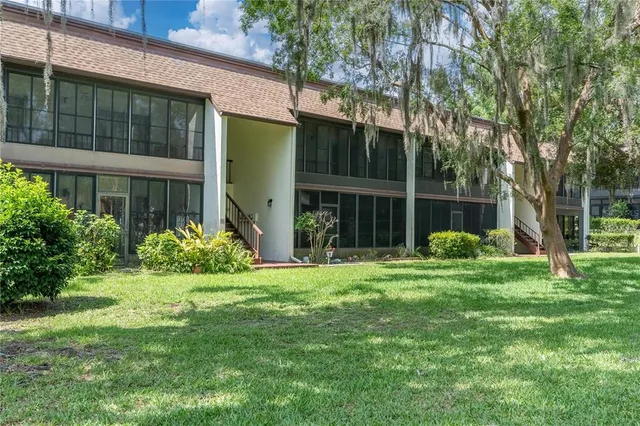 a view of a house with a yard and plants