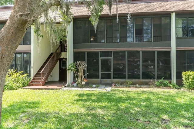 a view of a house with backyard porch and garden