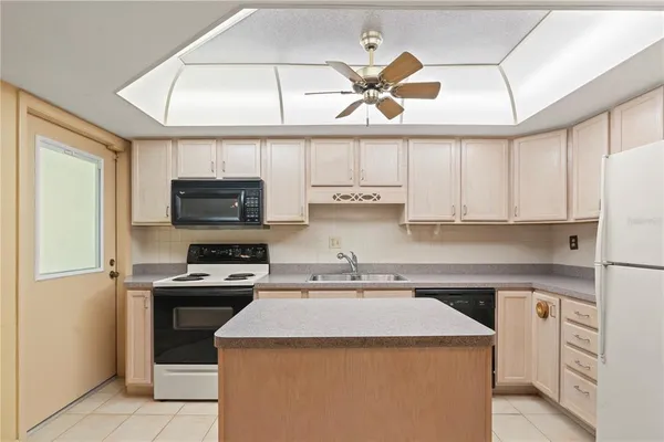 a kitchen with cabinets stainless steel appliances and a counter space