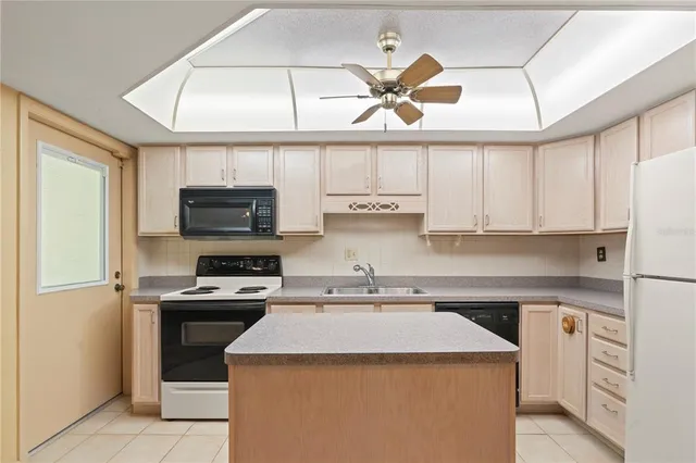 a kitchen with cabinets stainless steel appliances and a counter space