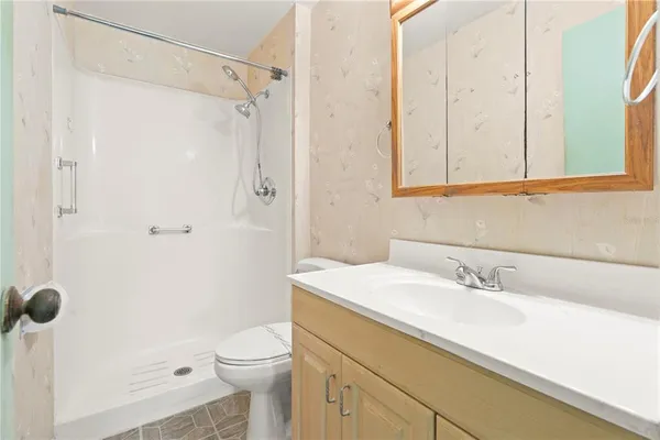 a view of a livingroom with an empty space and a ceiling fan