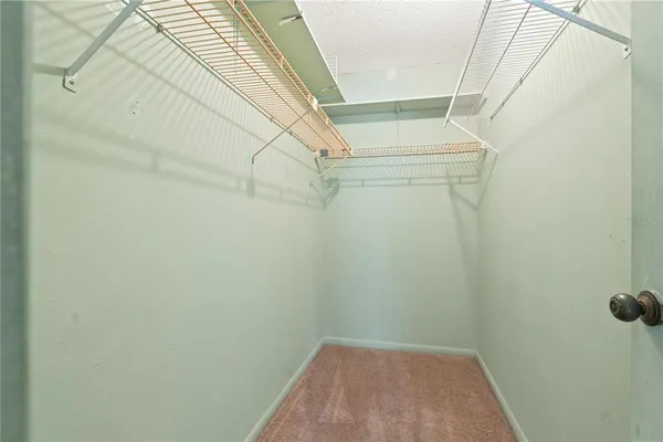 a view of a room with a ceiling fan and a shower