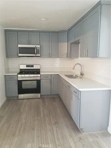 a kitchen with a sink cabinets and stainless steel appliances