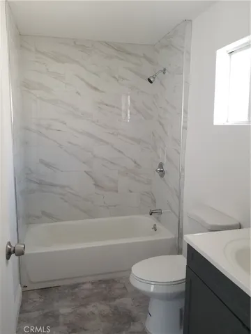 a bathroom with a toilet and a bathtub
