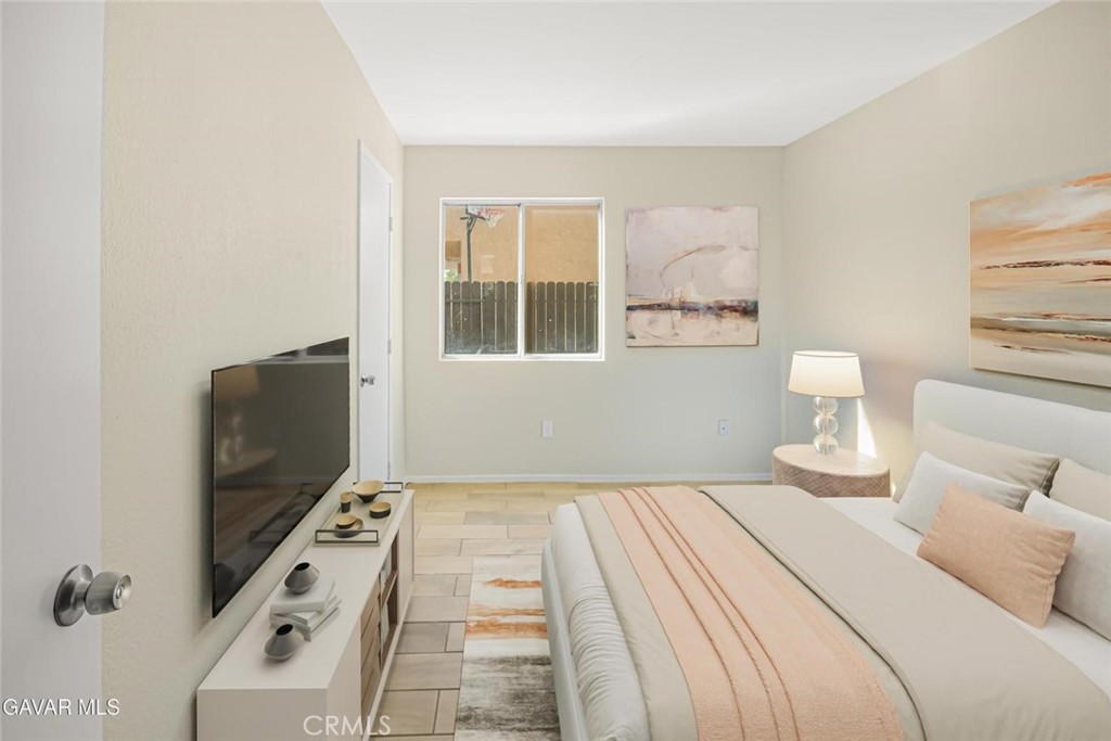 44910 12th Street East Lancaster, CA 93535 - Photo 16 of 47 a bedroom with a bed and a flat tv screen next to a window