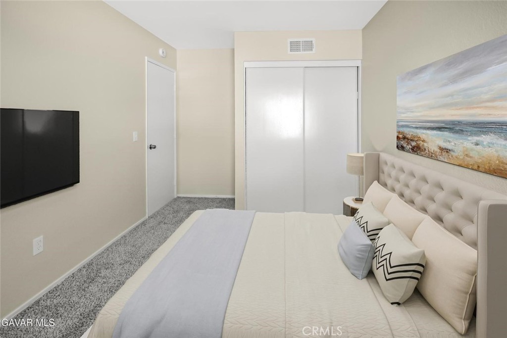44910 12th Street East Lancaster, CA 93535 - Photo 34 of 47 a bedroom with a bed and a flat screen tv