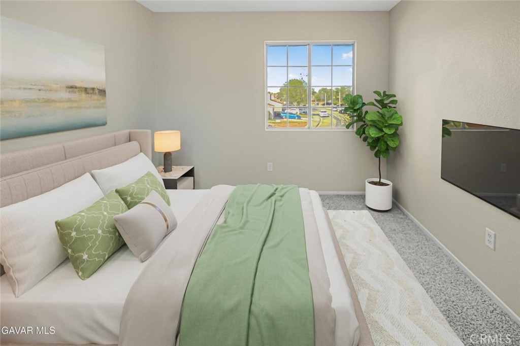 44910 12th Street East Lancaster, CA 93535 - Photo 36 of 47 a bedroom with a bed and a potted plant