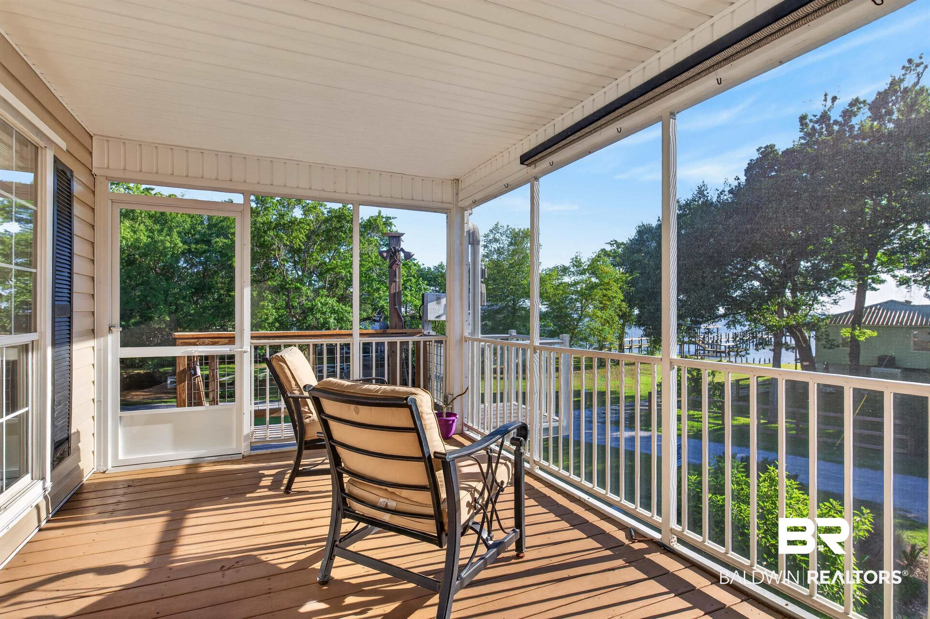 9624 North Bay Street Foley, AL 36535 - Photo 37 of 59 Screened porch featuring wood-finish flooring, white railing, white ceiling, exterior siding, and operable window shutters