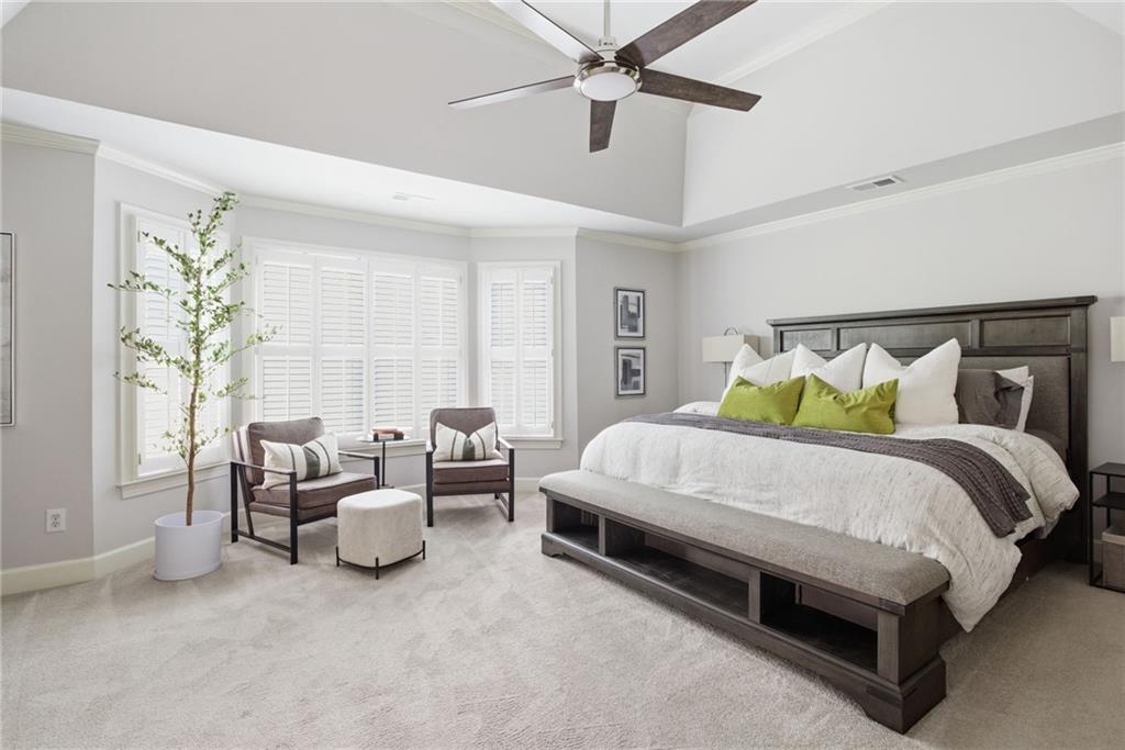 5335 Cottage Farm Road Johns Creek, GA 30022 - Photo 20 of 60 a spacious bedroom with a bed and a chandelier