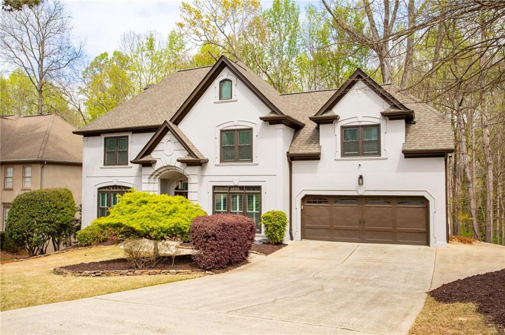 5335 Cottage Farm Road Johns Creek, GA 30022 - Photo 2 of 60 a front view of a house with a yard and garage