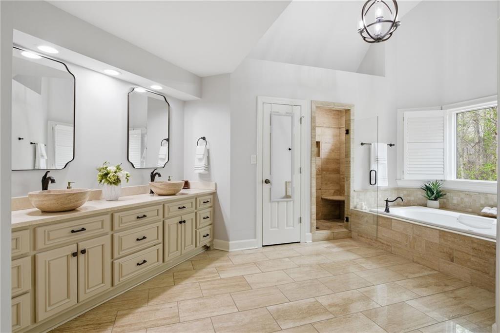 5335 Cottage Farm Road Johns Creek, GA 30022 - Photo 23 of 60 a spacious bathroom with a granite countertop tub sink a mirror a vanity and a shower
