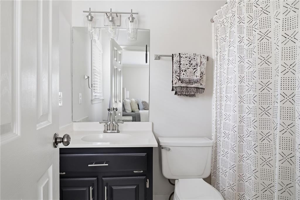5335 Cottage Farm Road Johns Creek, GA 30022 - Photo 32 of 60 a bathroom with a sink a toilet and a mirror