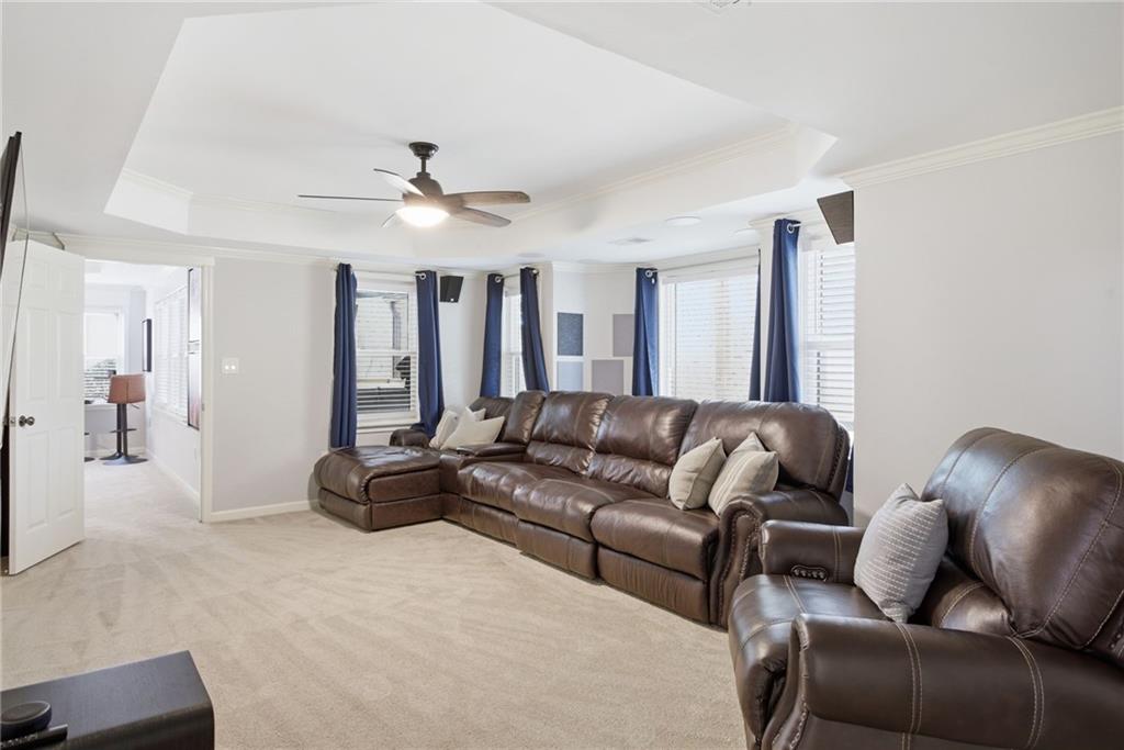 5335 Cottage Farm Road Johns Creek, GA 30022 - Photo 34 of 60 a living room with furniture ceiling fan and a rug