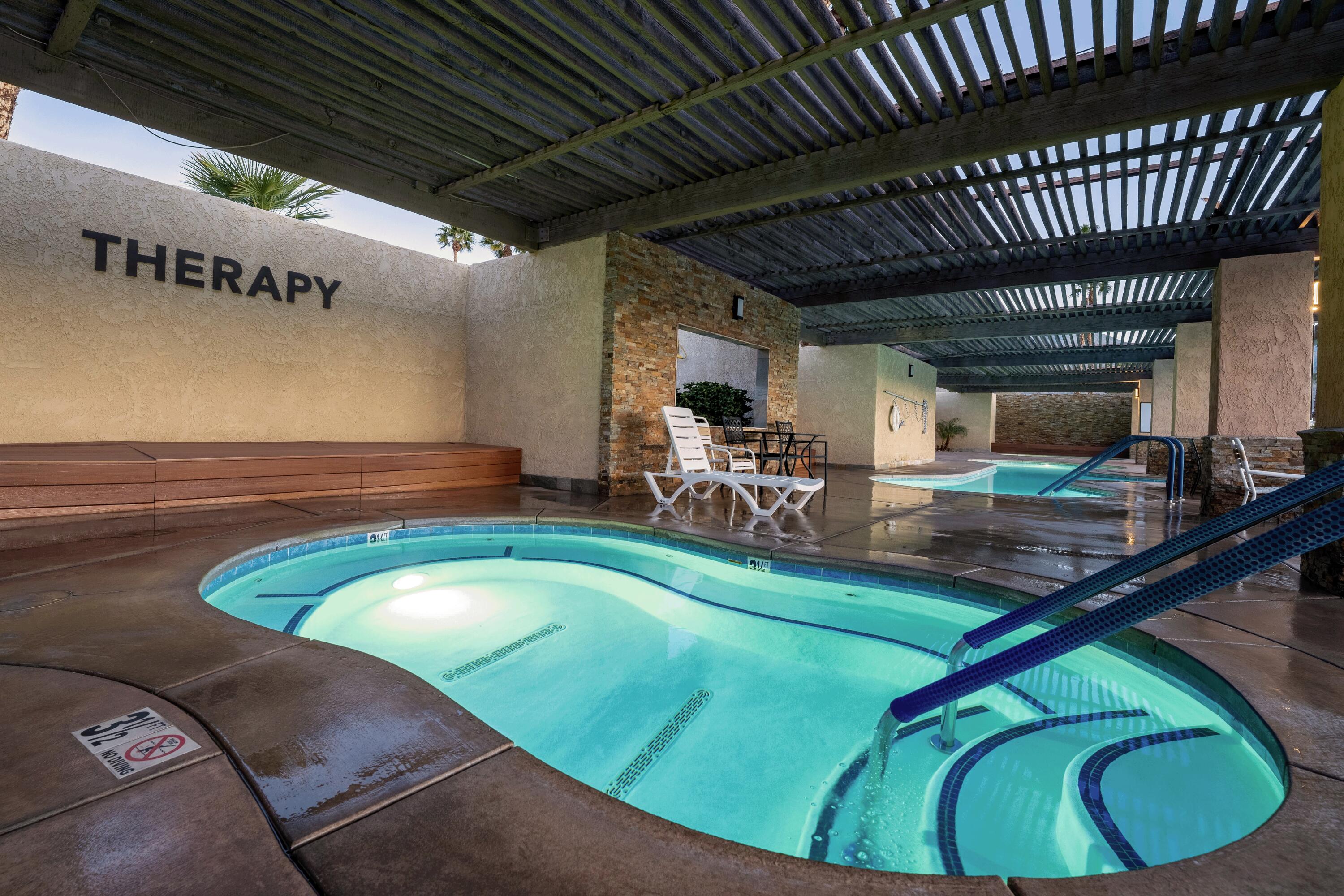 74711 Dillon Road, Unit 392 Desert Hot Springs, CA 92241 - Photo 40 of 46 a view of a swimming pool with chairs