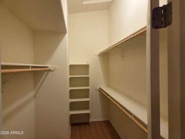 a view of walk in closet with empty racks