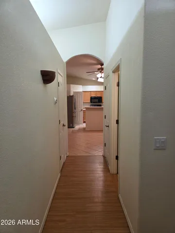 a view of a hallway with wooden floor