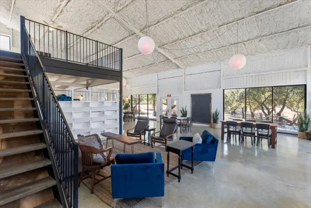 a living room with furniture a rug and a ceiling fan