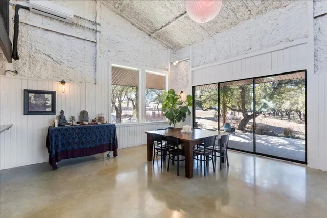 a living room with furniture a flat screen tv and kitchen view