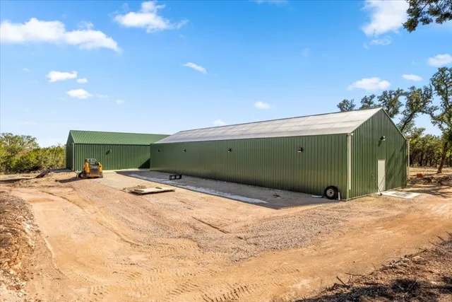 a view of a yard with plants and trees