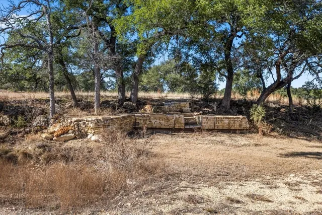 a view of a yard with wooden fence