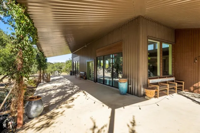 a open kitchen with lots of counter space a sink and dining table and chairs