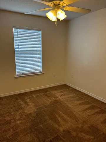 a view of an empty room with a windows