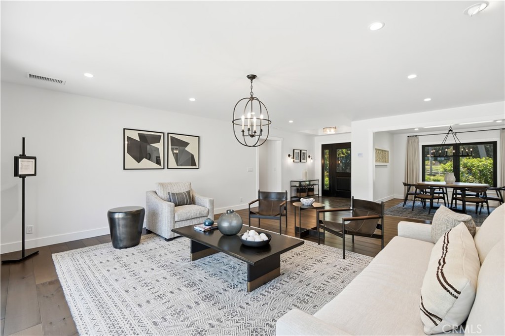 24884 Jim Bridger Road Hidden Hills, CA 91302 - Photo 3 of 31 a living room with furniture a chandelier and a rug