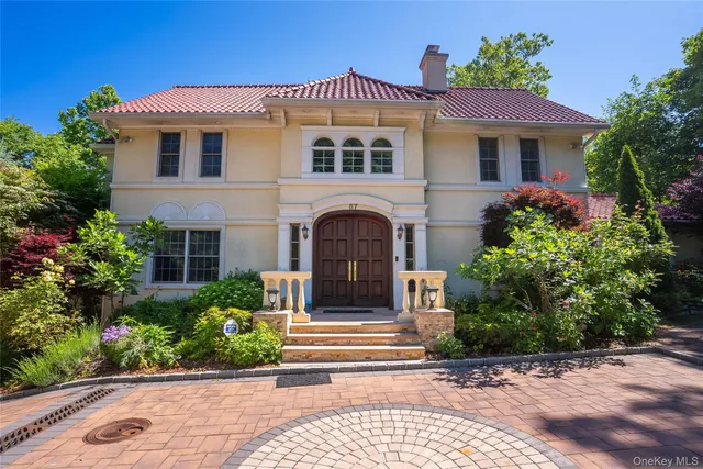 a front view of a house with a garden