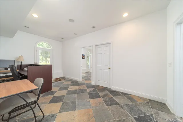 a view of an empty room with windows and closet