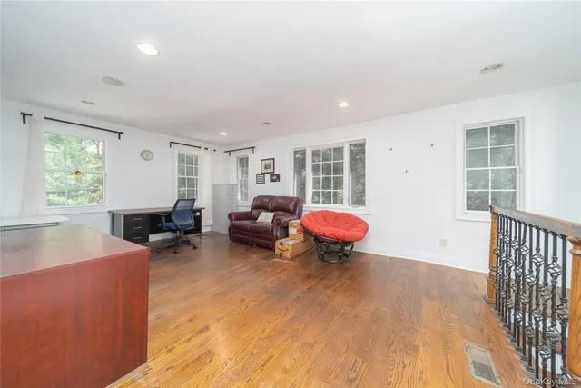 a bed room with furniture and a wooden floor