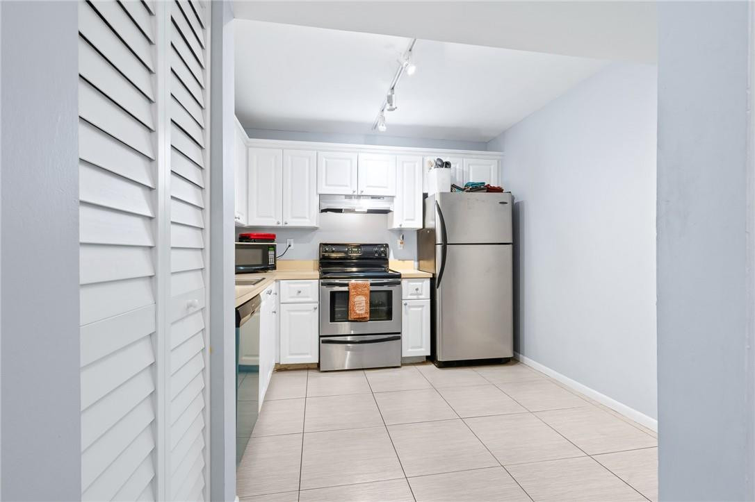 721 North Pine Island Road, Unit 302 Plantation, FL 33324 - Photo 15 of 25 a kitchen with a refrigerator sink and cabinets
