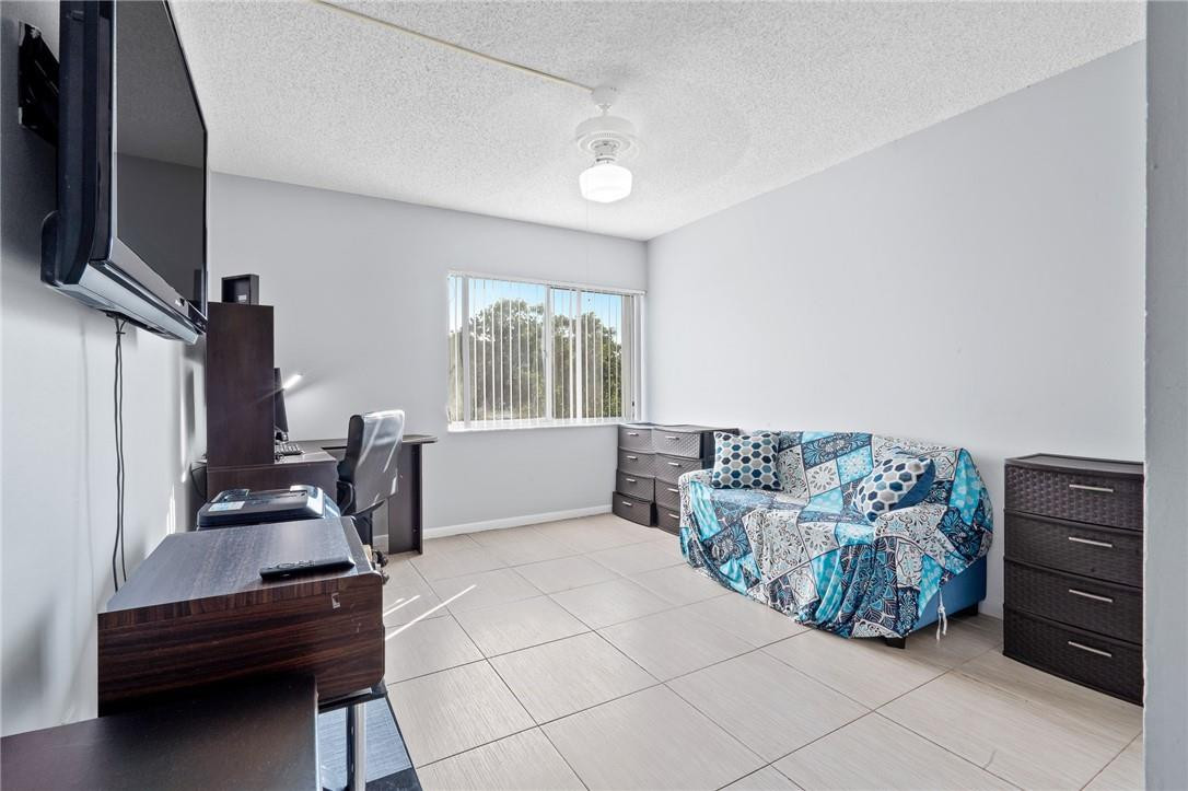 721 North Pine Island Road, Unit 302 Plantation, FL 33324 - Photo 16 of 25 a bedroom with furniture and a window