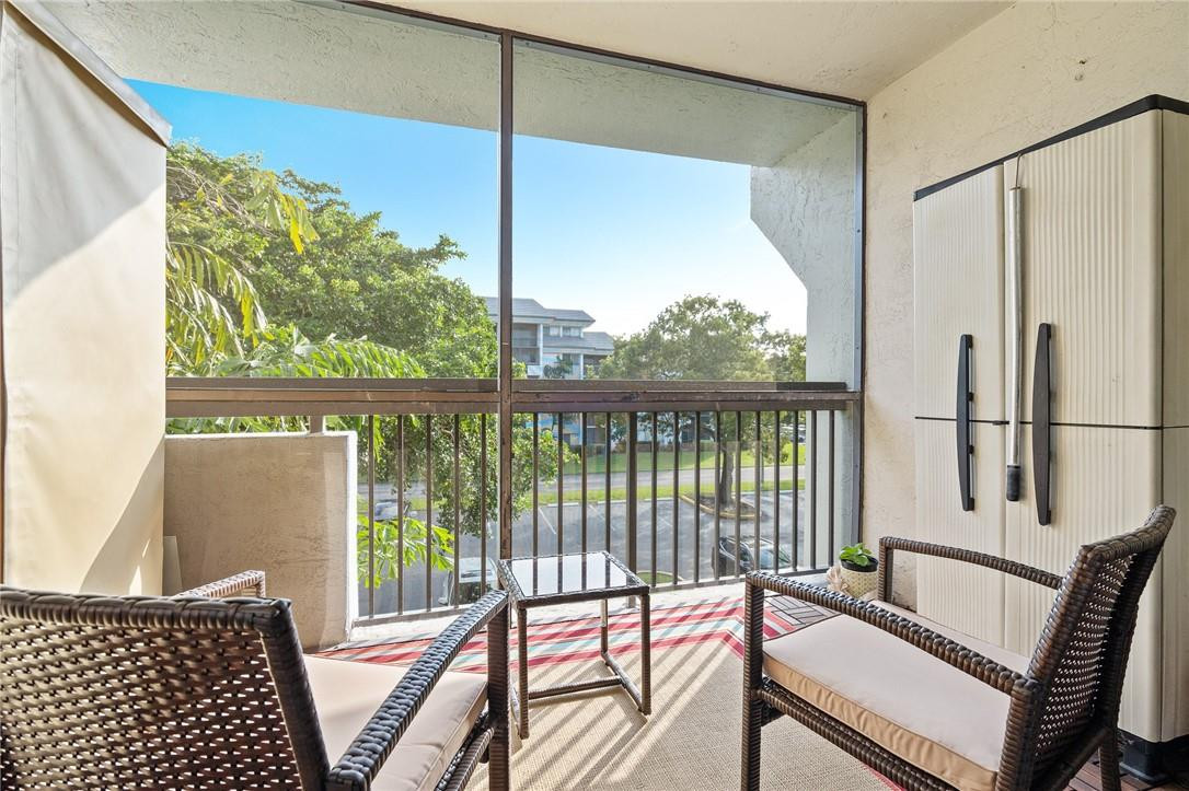 721 North Pine Island Road, Unit 302 Plantation, FL 33324 - Photo 2 of 25 a living room with a large window