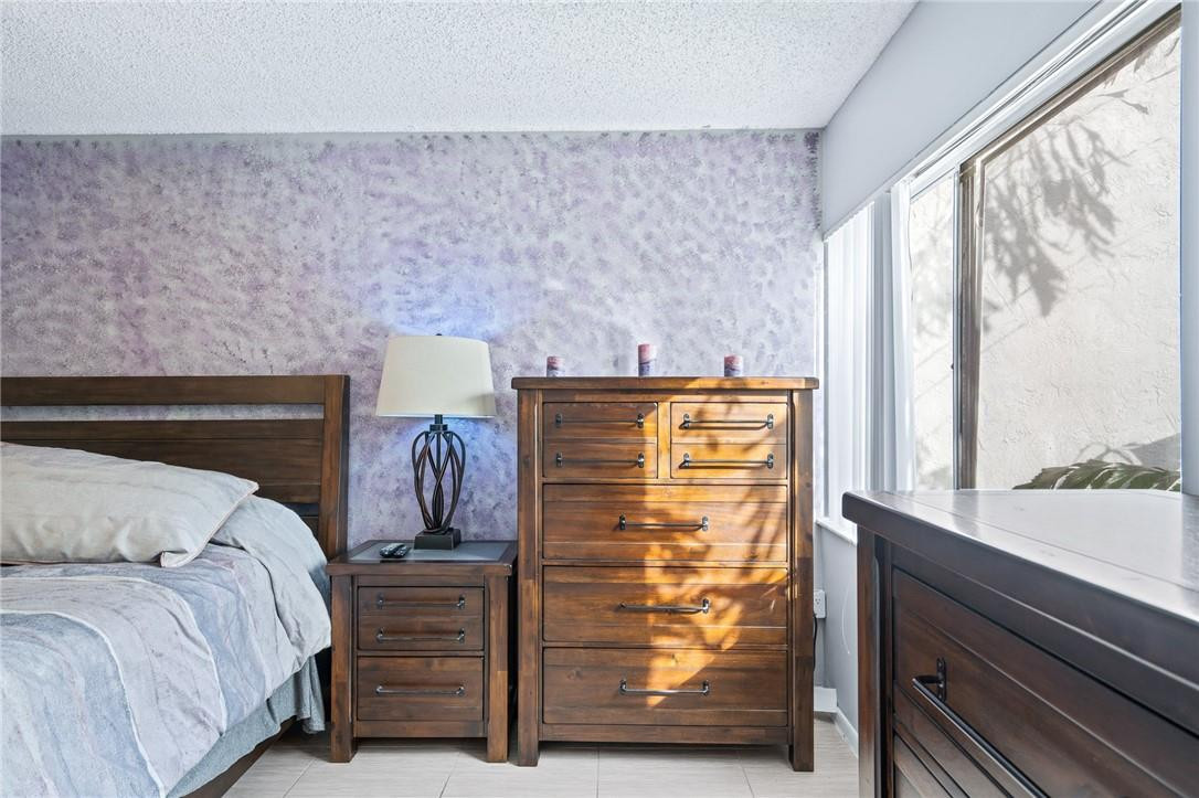 721 North Pine Island Road, Unit 302 Plantation, FL 33324 - Photo 25 of 25 a view of bedroom with furniture and large window