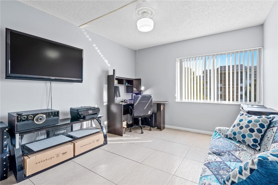 721 North Pine Island Road, Unit 302 Plantation, FL 33324 - Photo 4 of 25 a living room with furniture and a flat screen tv
