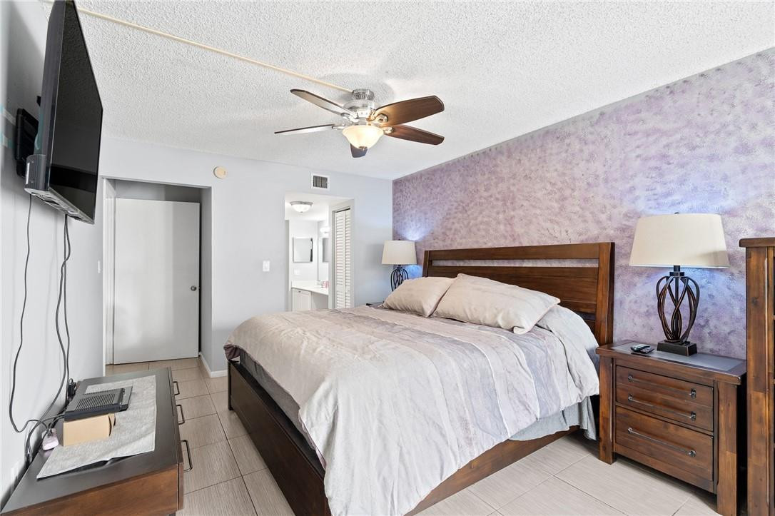 721 North Pine Island Road, Unit 302 Plantation, FL 33324 - Photo 6 of 25 a bedroom with bed and tv
