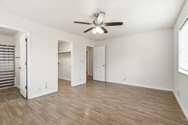 a view of a room with wooden floor