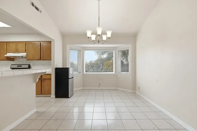 a kitchen with granite countertop cabinets stainless steel appliances and a sink