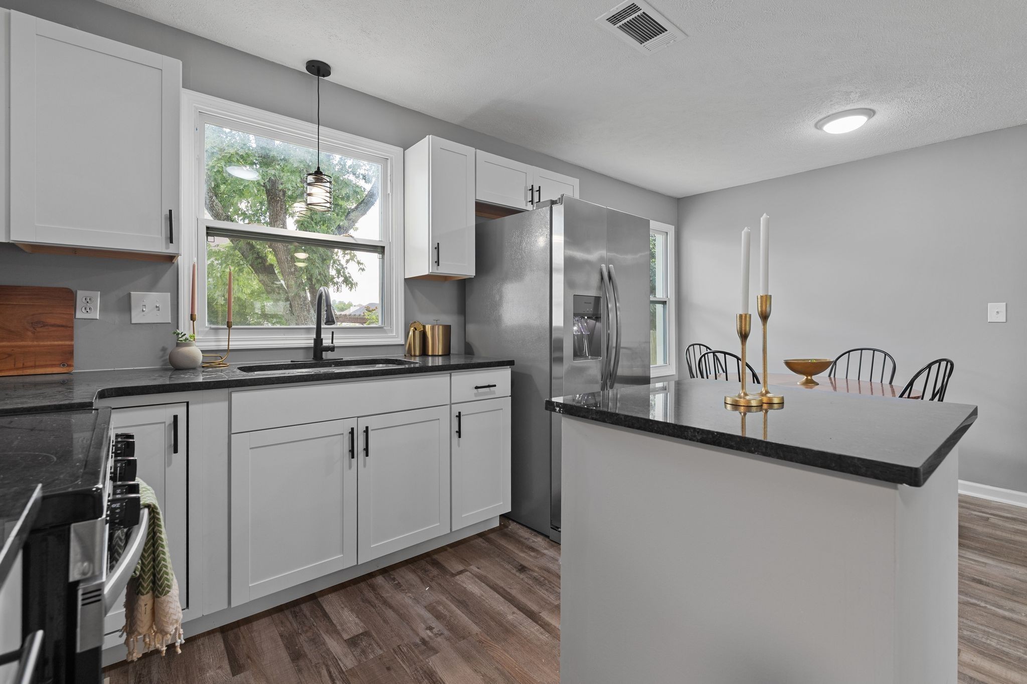 544 Stones River Road La Vergne, TN 37086 - Photo 12 of 26 a kitchen with stainless steel appliances granite countertop a sink a stove and a refrigerator