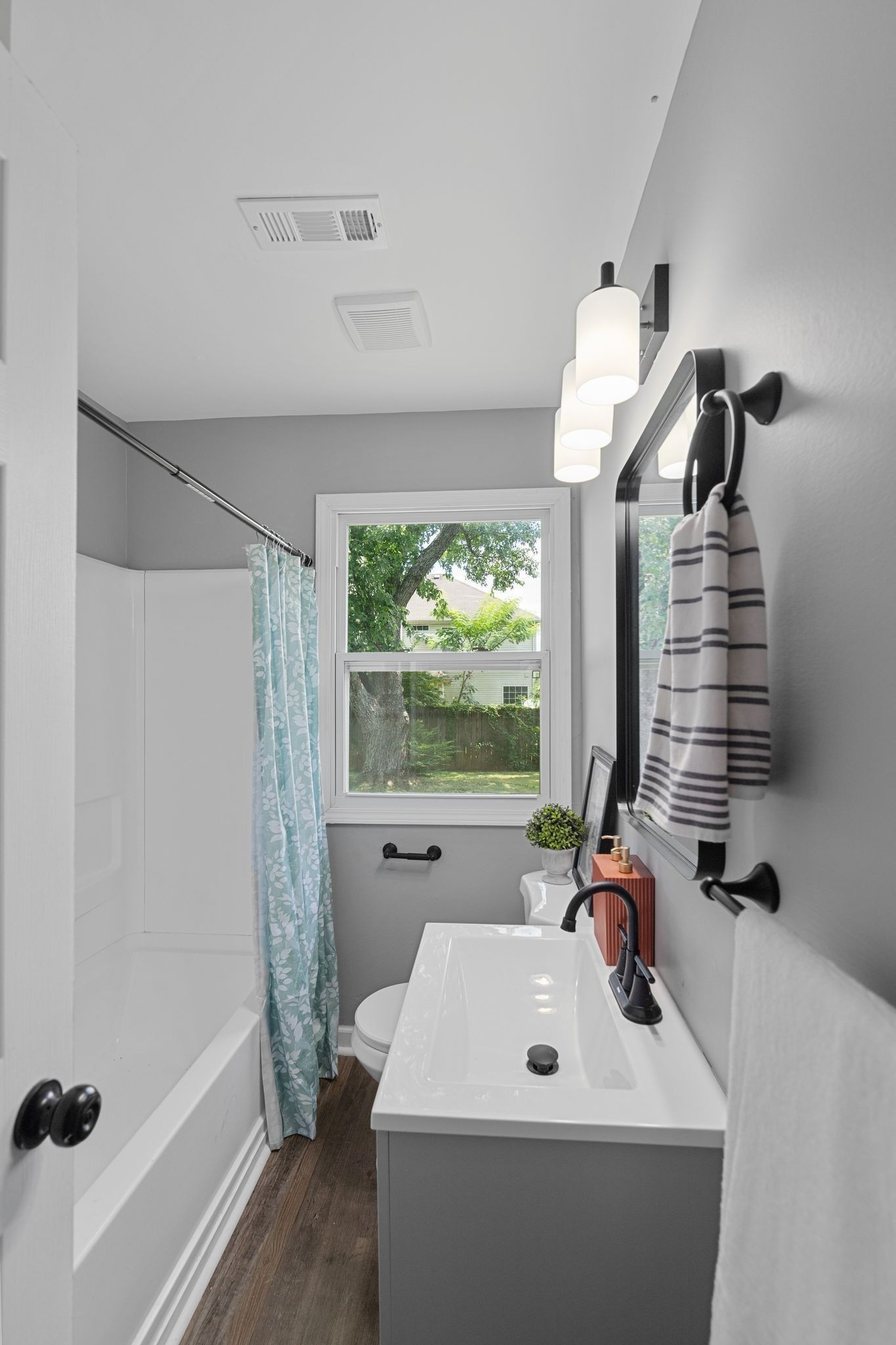 544 Stones River Road La Vergne, TN 37086 - Photo 21 of 26 a bathroom with a white tub a sink and a large window