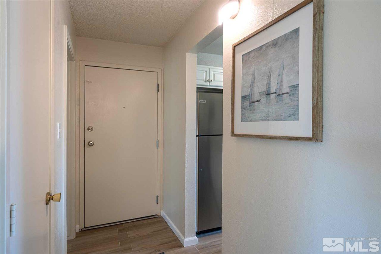 3915 Clear Acre Lane, Unit 149 Reno, NV 89512 - Photo 12 of 21 a view of a hallway with wooden floor and closet