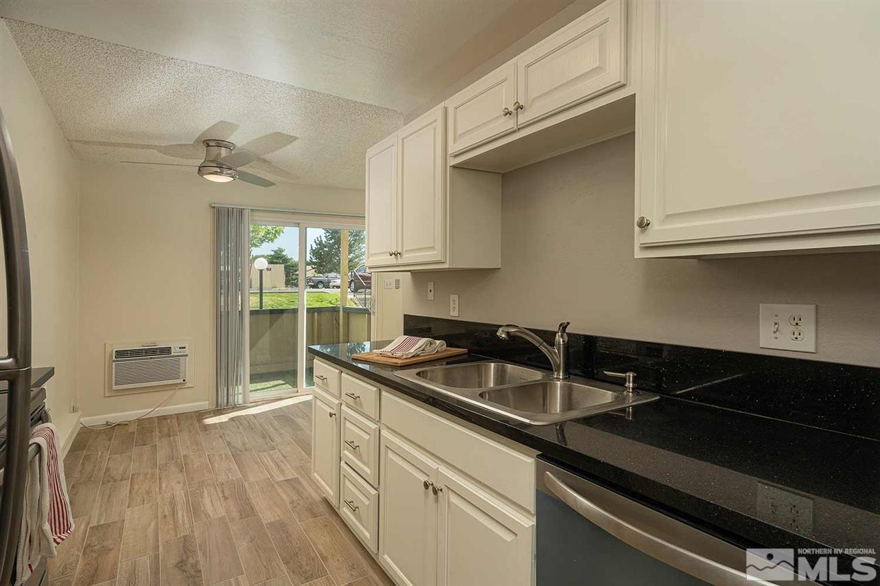 3915 Clear Acre Lane, Unit 149 Reno, NV 89512 - Photo 2 of 21 a kitchen that has a sink a stove and cabinets