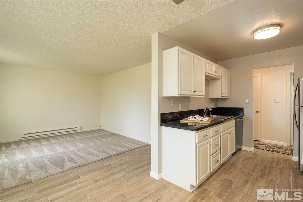 3915 Clear Acre Lane, Unit 149 Reno, NV 89512 - Photo 3 of 21 a kitchen with granite countertop a stove and a sink