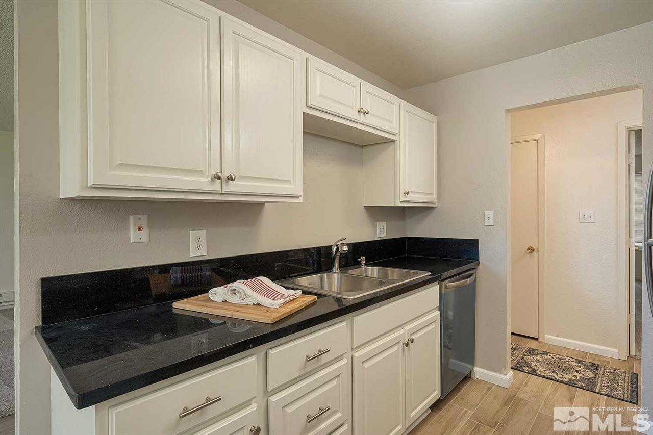 3915 Clear Acre Lane, Unit 149 Reno, NV 89512 - Photo 7 of 21 a kitchen with granite countertop white cabinets and a sink