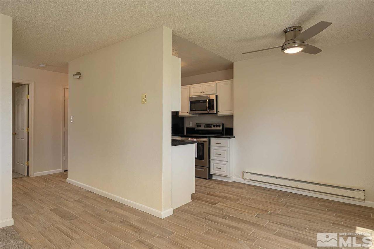 3915 Clear Acre Lane, Unit 149 Reno, NV 89512 - Photo 8 of 21 a kitchen with a refrigerator and a stove top oven